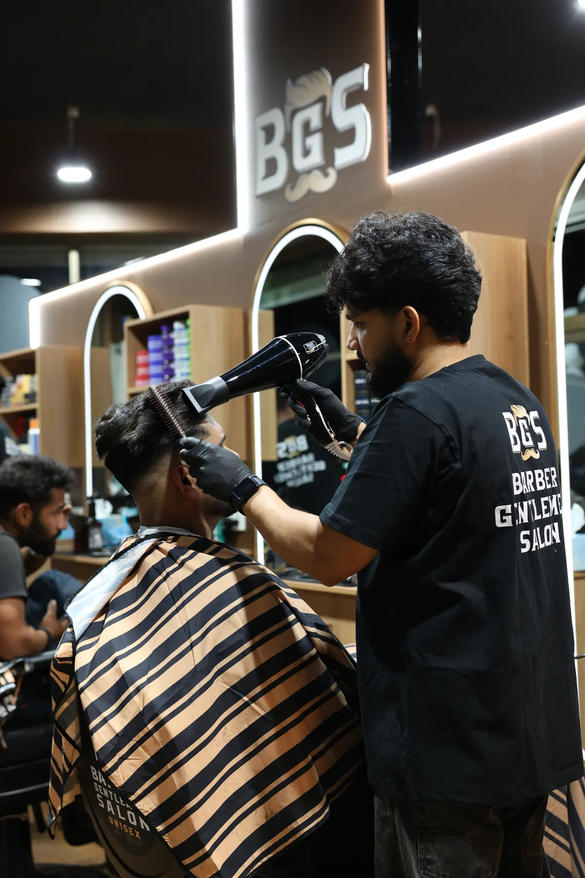 An artist blow-drying a client's hair