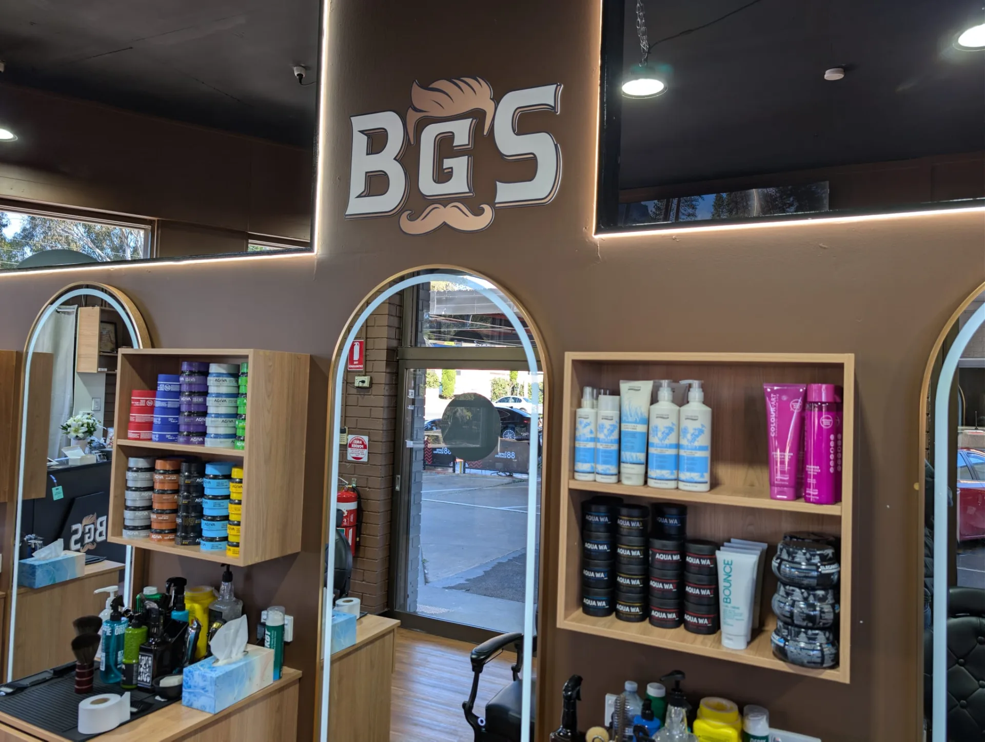The BGS mark above an arched mirror, retail shelves either side