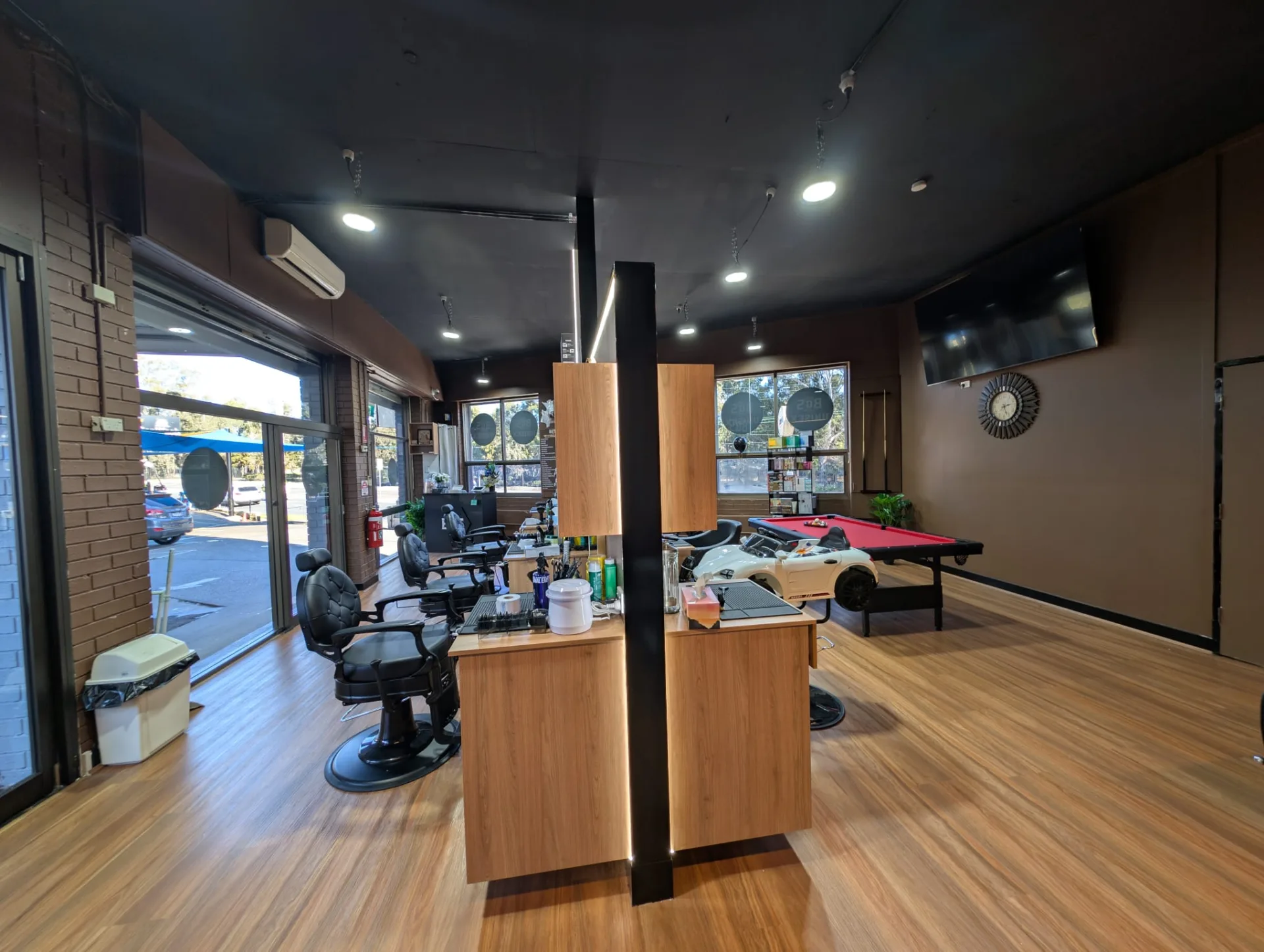 Daylight across the salon floor, from the stations to the games corner