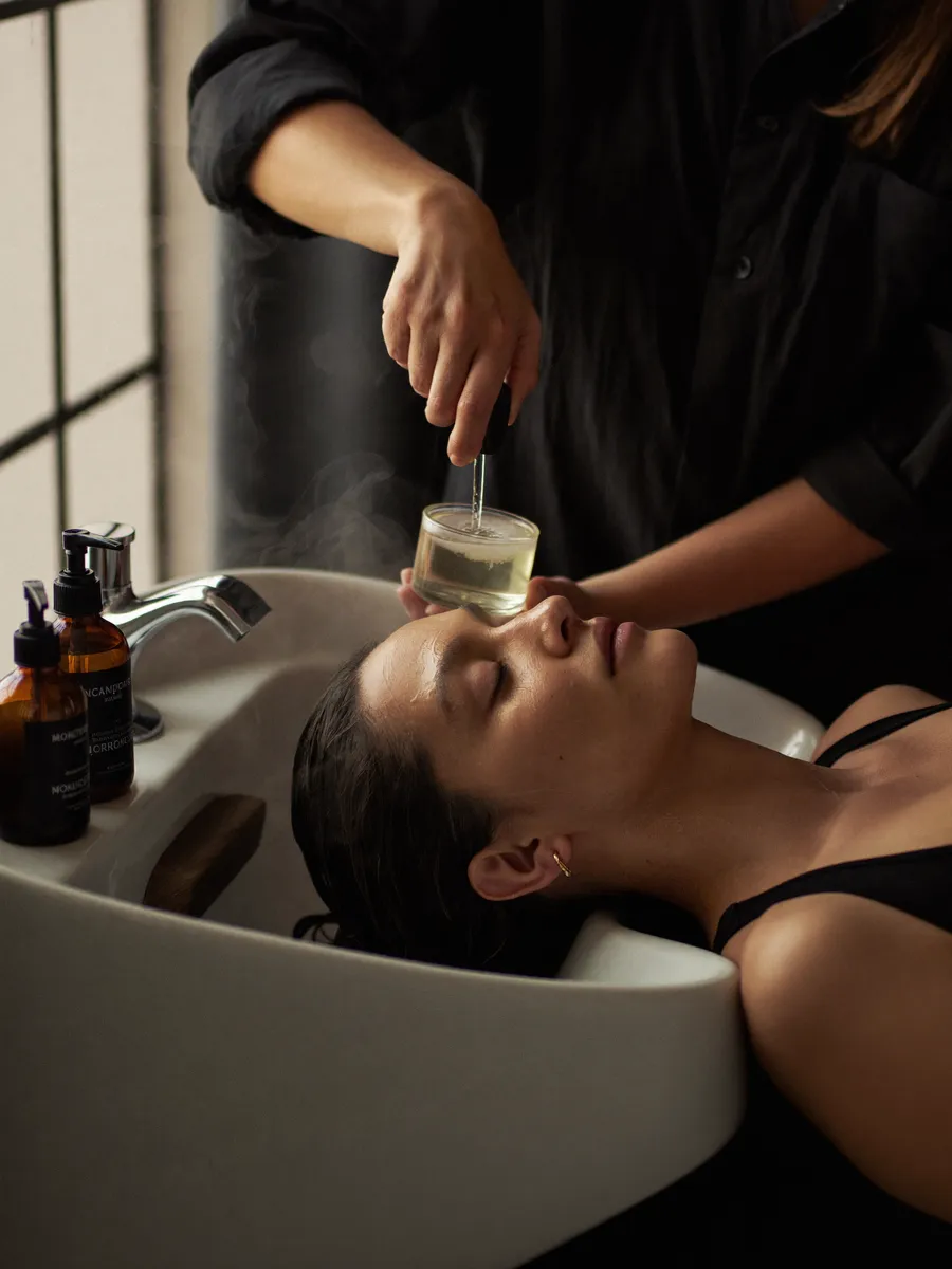 A nourishing treatment being worked through a client's hair