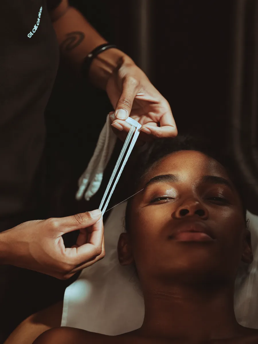 Precise eyebrow threading in progress